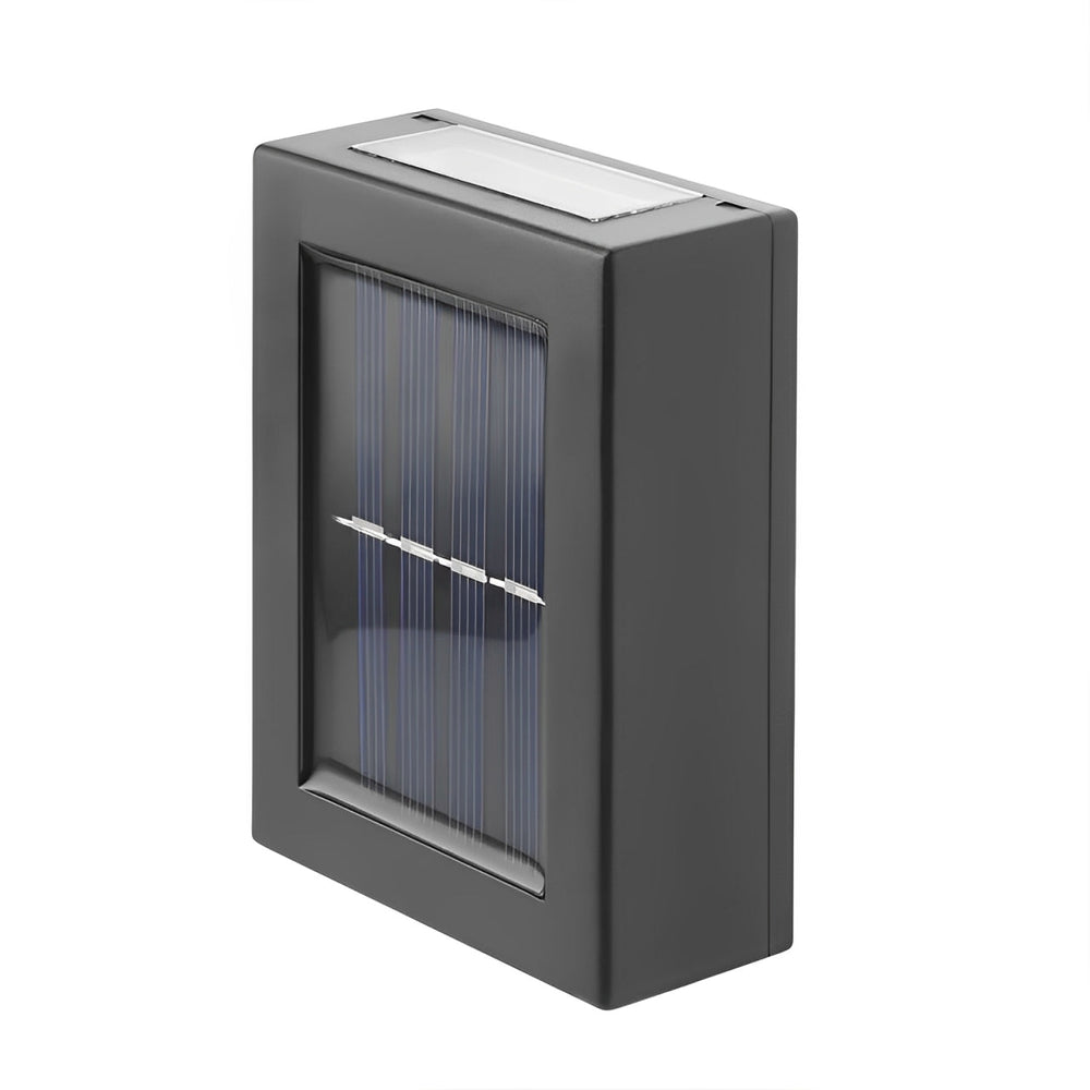 Close-up of the black rectangular light from an angle, showing the solar panel on its front and the light slot on top. 2