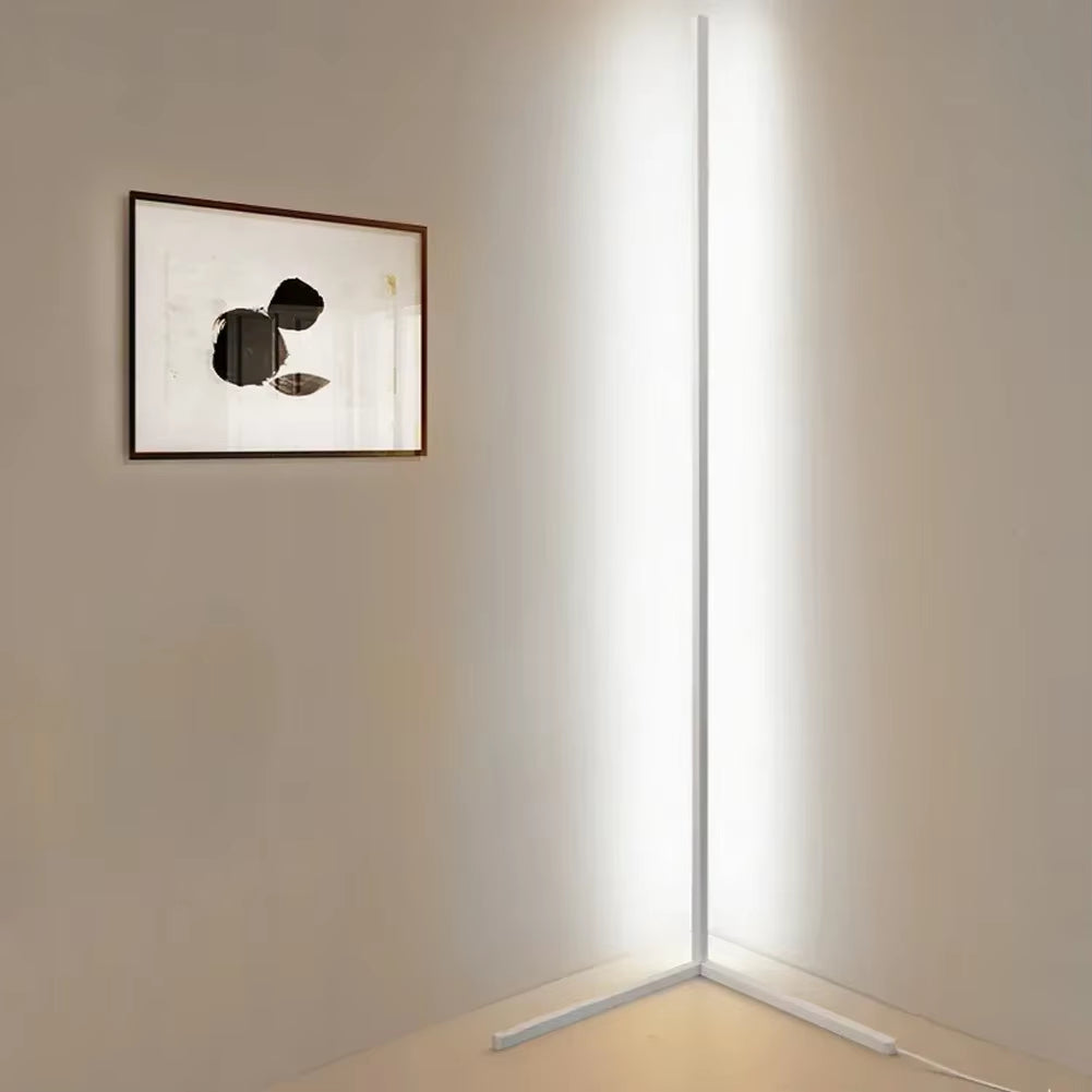 White corner floor lamp shining bright cool white light in a room corner, with a framed abstract print on the wall. 5