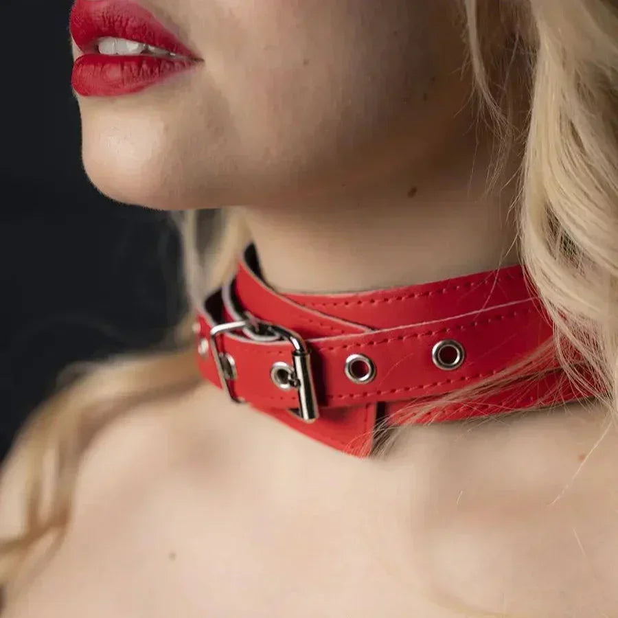 Detail of the red stitched collar with eyelets and a silver buckle