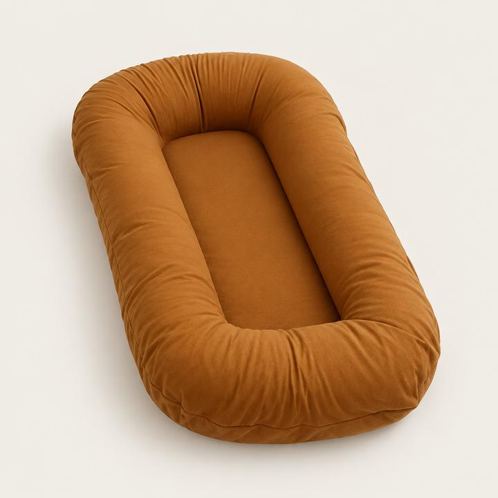 Empty caramel brown support pillow with a thick rounded rim, photographed at an angle on a light background 9
