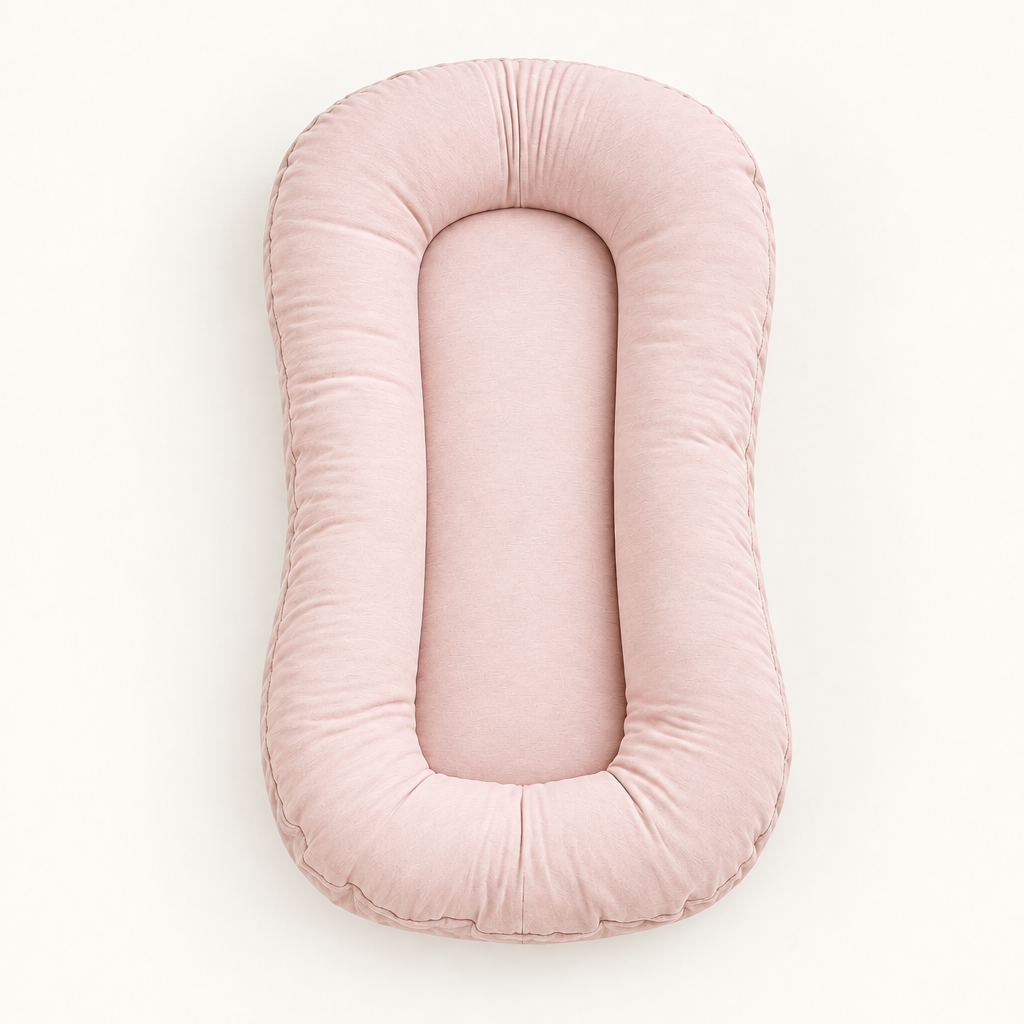 Empty blush-pink pillow seen from above, showing its soft rounded rim and flat center 10