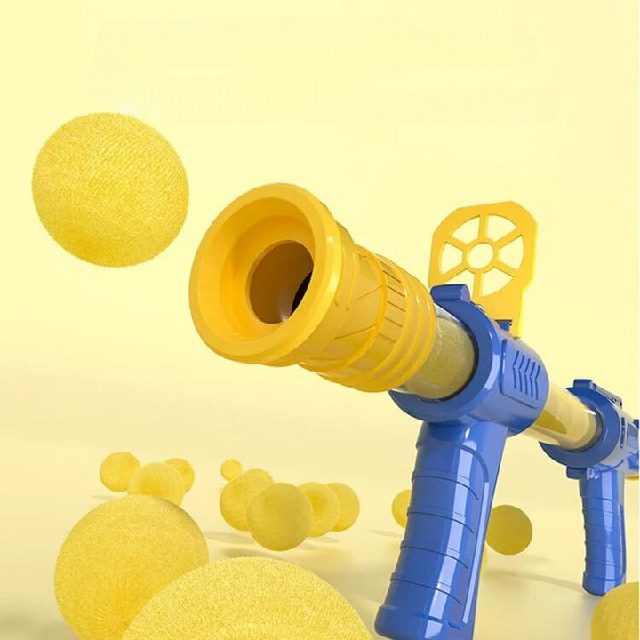 Close-up of the yellow muzzle and blue grip of a foam ball blaster with balls floating nearby 4