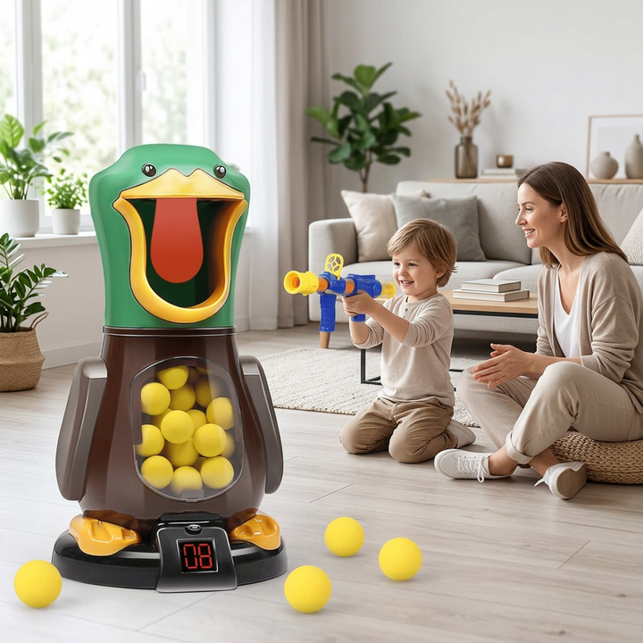 Smiling boy aims the blue foam-ball blaster at the green duck target while his mother watches in a bright living room 1