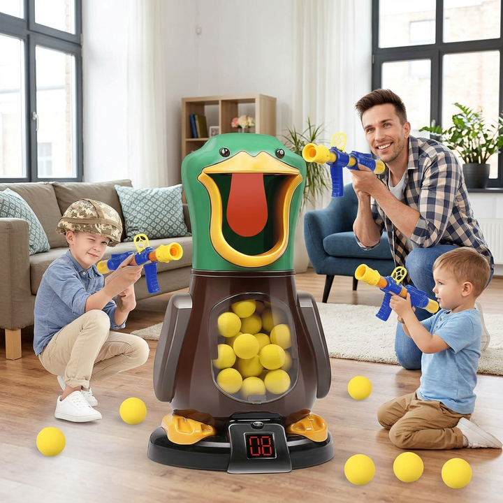 A father and two boys kneel in a living room aiming foam-ball guns at the green duck target 1