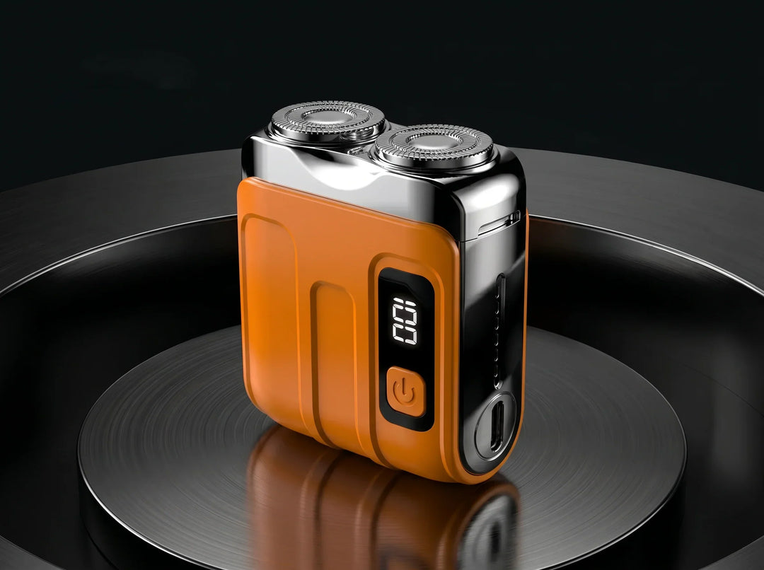 Orange compact twin-head shaver with chrome top, digital display and USB-C port on a glossy black circular platform.