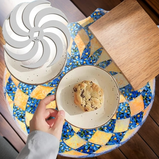 Blue floral and orange placemat under a plate with a cookie, with a white spiral template overlaid.