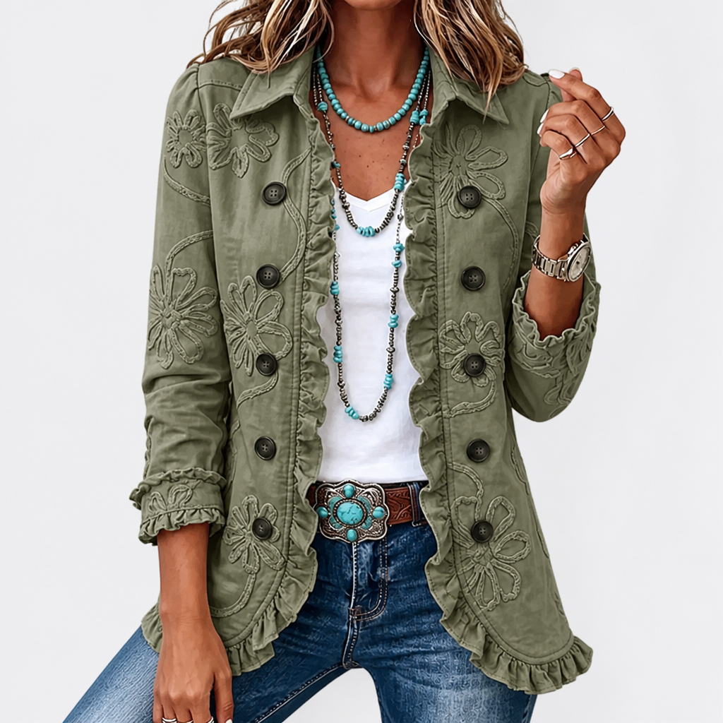 Light sage green floral embroidered utility jacket with raised floral embroidery and ruffled edges worn open over a white tee.