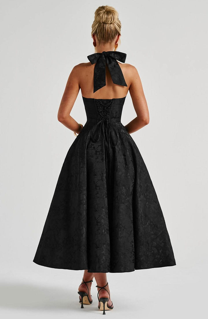 Red floral halter midi dress, back view with open back and corset lacing.