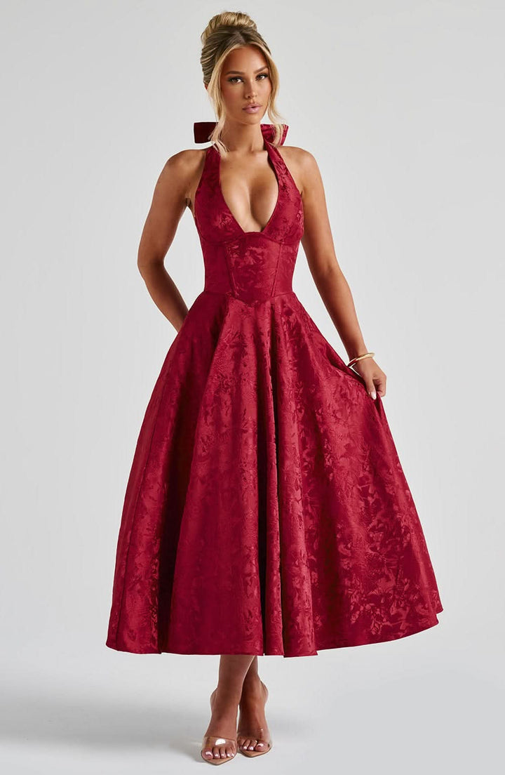 Red floral halter midi dress with a corset bodice and full circle skirt, front view.