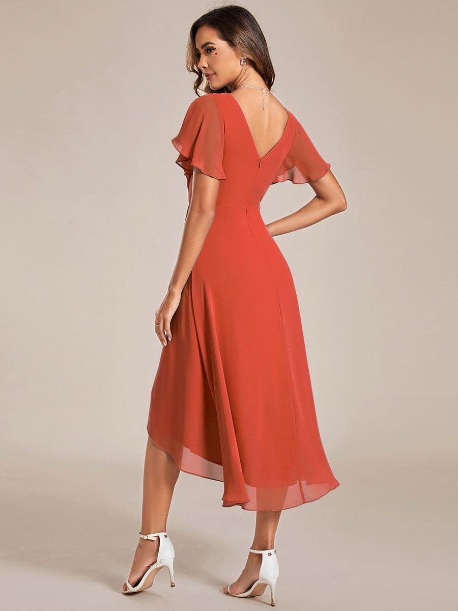 Back view of the burnt orange chiffon dress showing the V-shaped back, zipper and sweeping asymmetric hem. 93