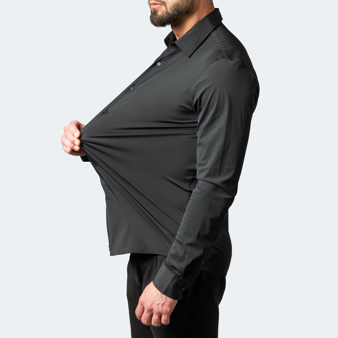 Men's black stretch dress shirt with chest fabric pulled outward, detail view.
