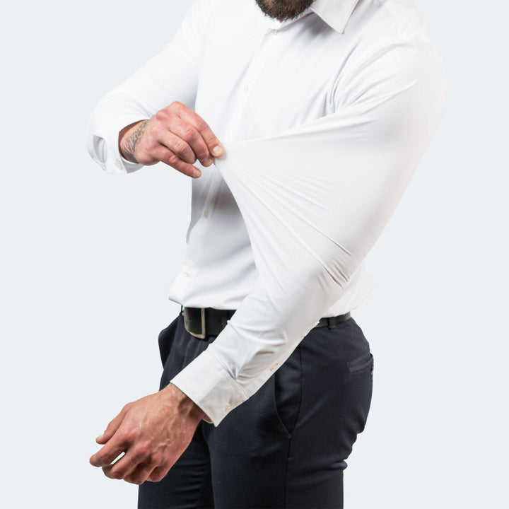 Men's white stretch dress shirt with sleeve fabric pulled outward, detail view.
