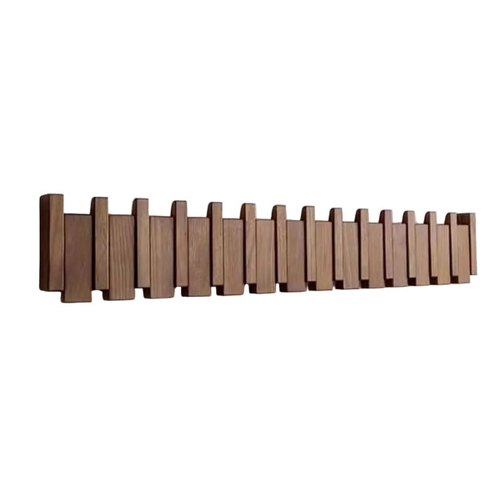 Brown wooden piano-style wall coat rack with staggered slats on a white background.