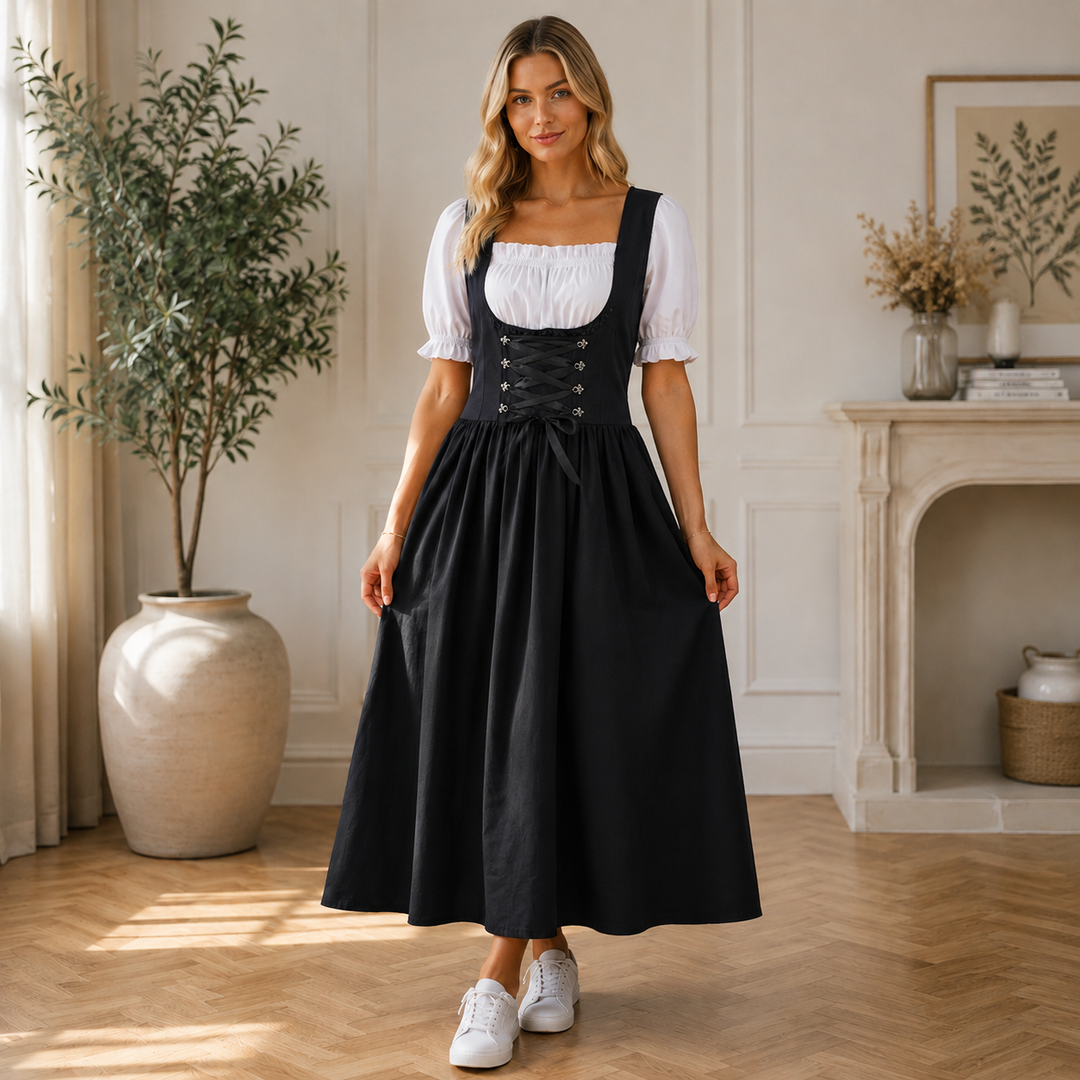Black dirndl dress with a corset-style lace-up bodice, white puff-sleeve blouse and white sneakers.