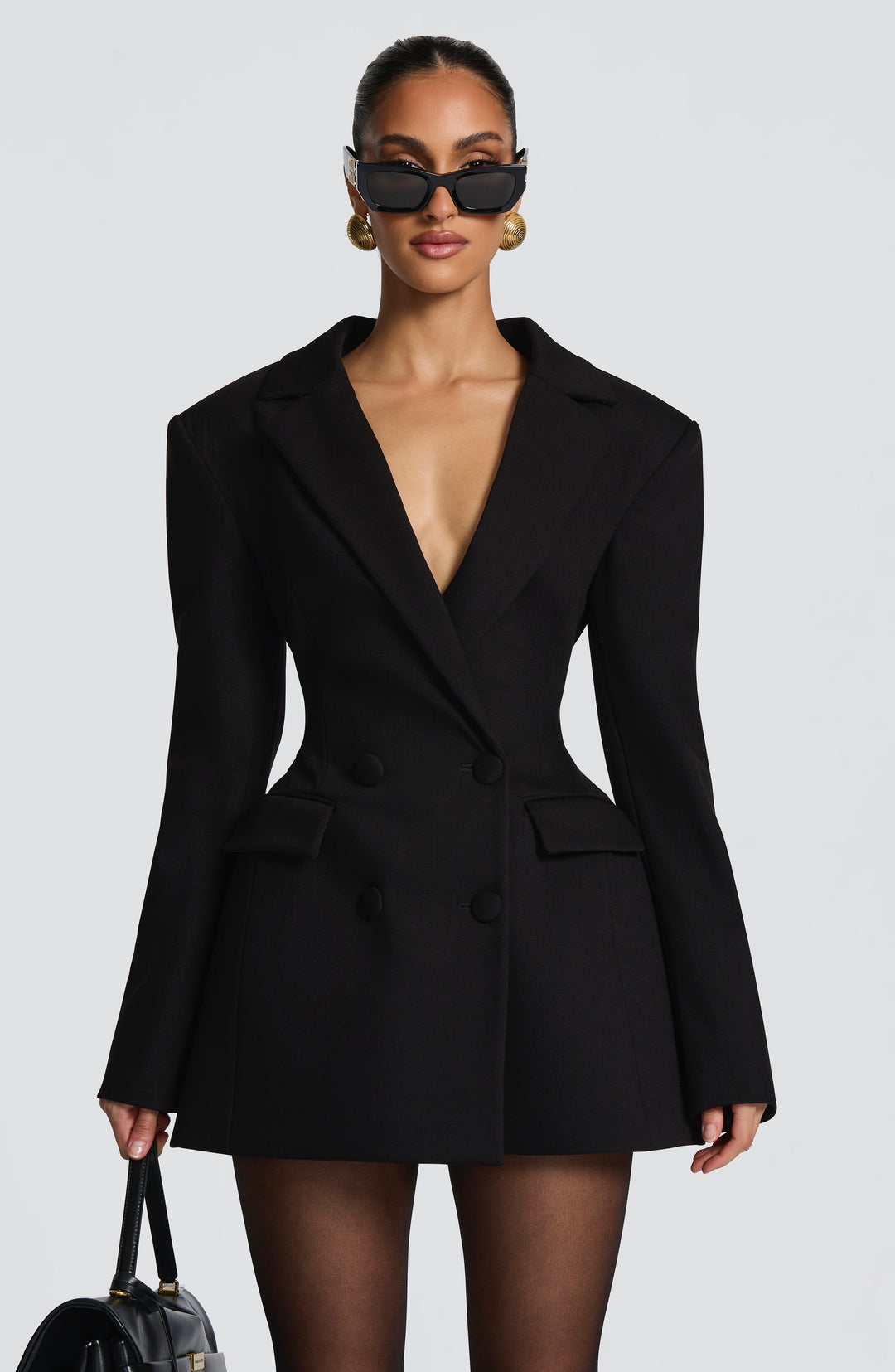 Black blazer mini dress with a cinched waist and flared skirt, another view.
