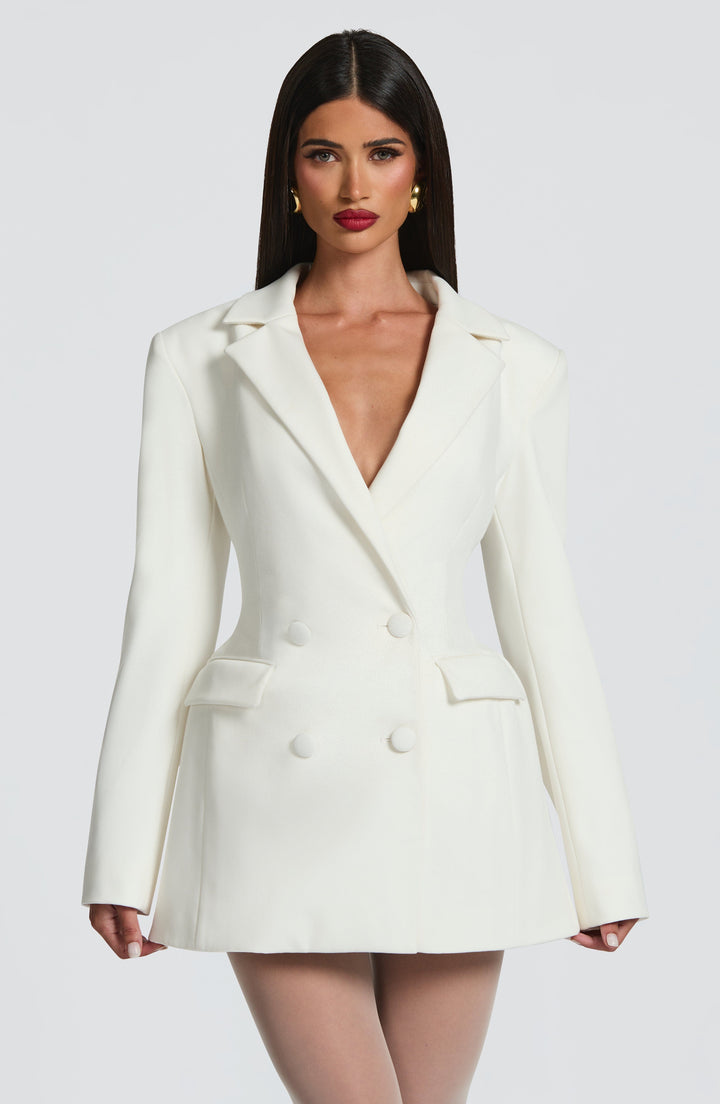 White double-breasted blazer mini dress with a nipped waist and flared skirt.