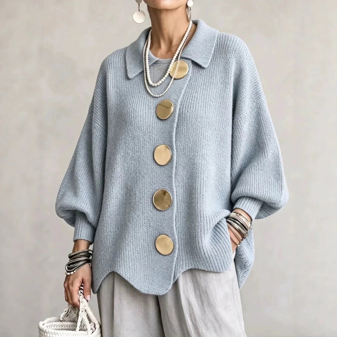 Light blue ribbed cardigan worn by a model with gray linen pants, showing gold buttons and a wavy hemline. 5
