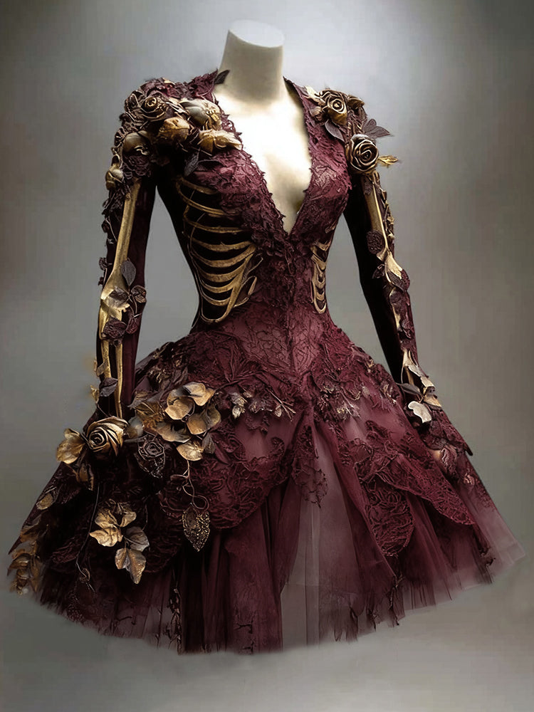 Burgundy version of the long-sleeved lace dress with golden skeleton print, gold roses and a flared tulle skirt on a mannequin.