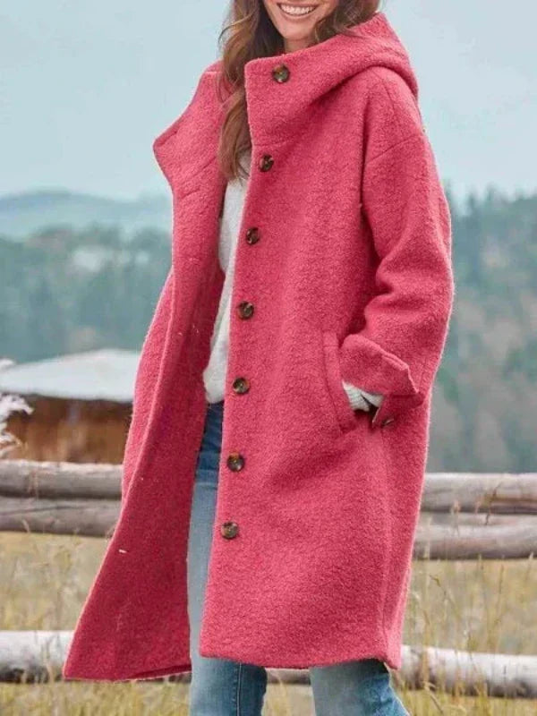 Women's black hooded coat buttoned up the front with side pockets, shown outdoors.