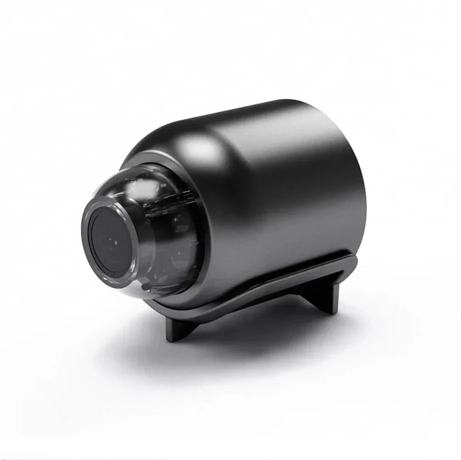 Front three-quarter view of the black cylindrical security camera with a clear dome lens housing and a small angled stand.