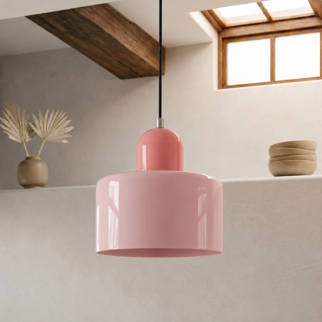 Glossy pink drum-shaped pendant lamp with a pink rounded cap, hanging on a black cord in a plaster-walled room with a wooden beam. 1