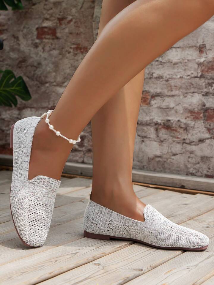 Light gray knit slip-on flats with pearl anklet, another view.