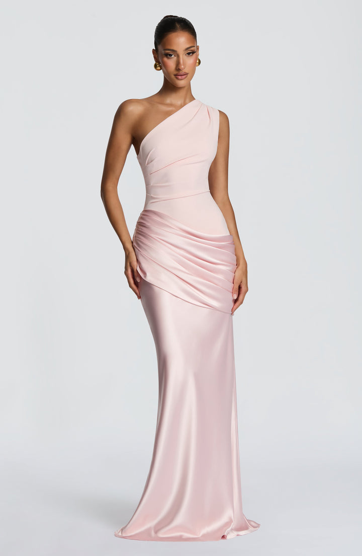 Pale pink gown shown from a slightly angled front, with the hand resting at the draped satin hip. 12