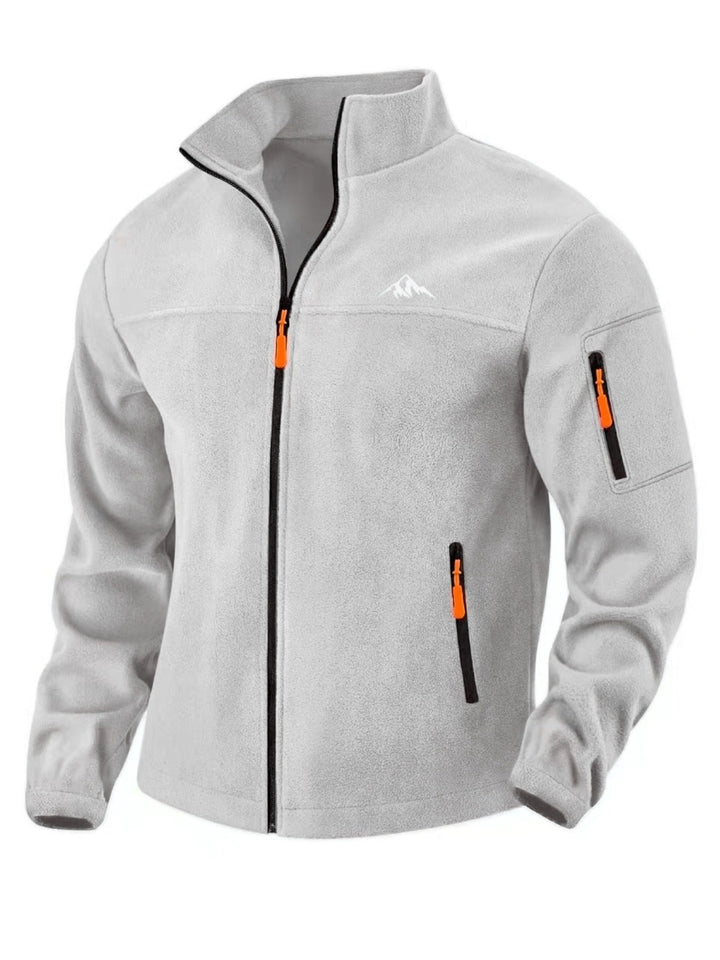 Front view of the light gray fleece jacket with stand collar, orange zipper pulls and sleeve pocket 3