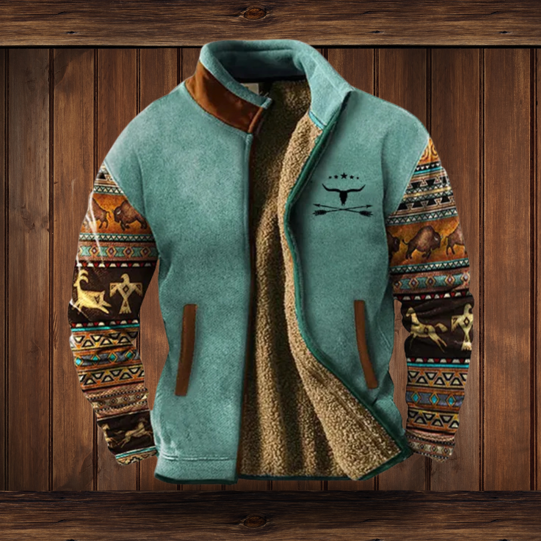 Teal fleece jacket detail on a wooden background, with patterned animal-motif sleeves, brown pocket trim and a sherpa lining.