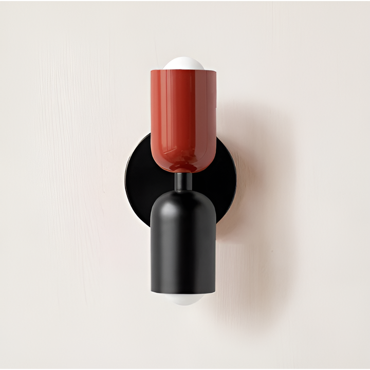 Wall light with a red upper head and black lower head on a round black backplate. 22
