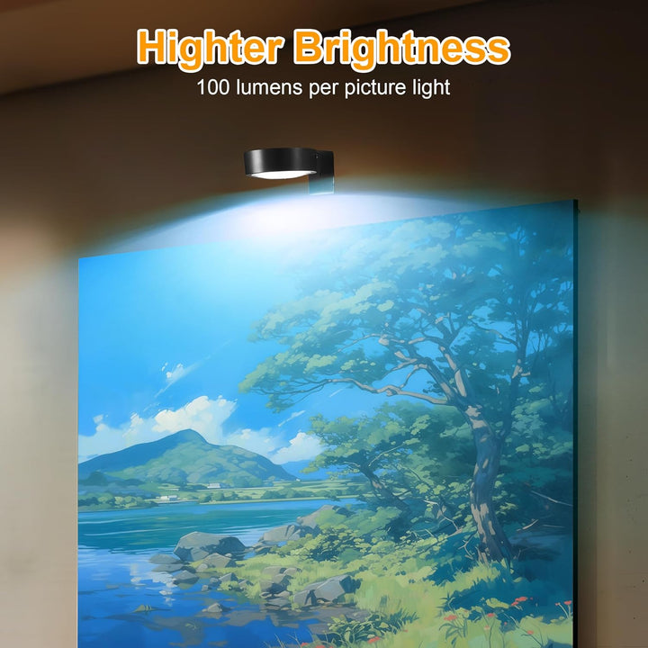 Black round light mounted above a framed landscape painting of a lake and tree, casting a bright cool-white glow on the artwork. 3