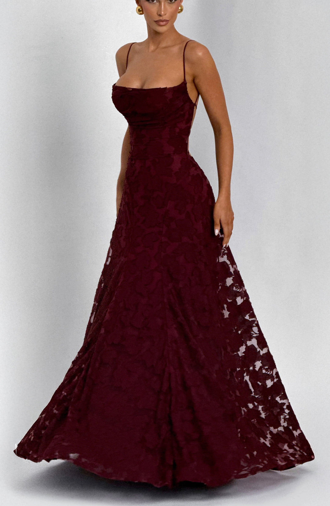 Elise Gingham Dress in burgundy with the skirt held out to one side and a flared hem.