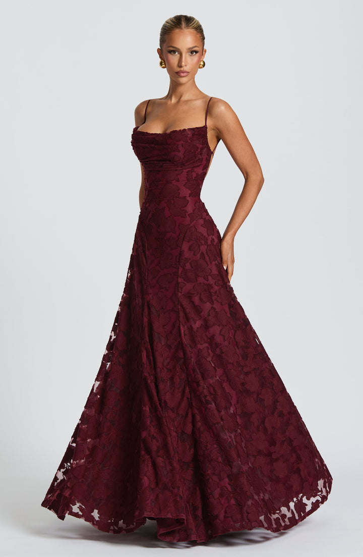 Elise Gingham Dress in burgundy with a full flared skirt and draped cowl neckline, angled view.