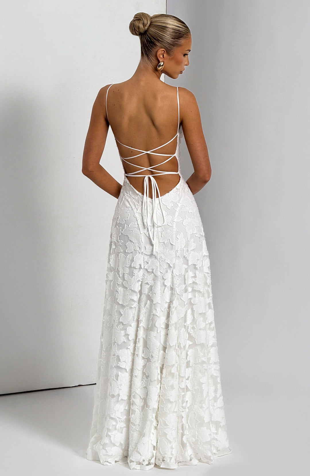 Elise Gingham Dress in white with a crisscross lace-up back and flowing skirt, back view.
