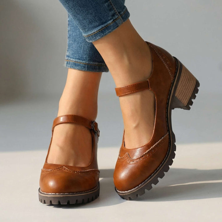 Tan brown Mary Janes with a perforated wingtip toe and chunky lugged sole.