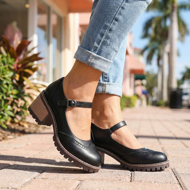 Black Mary Janes with buckled straps and block heels.