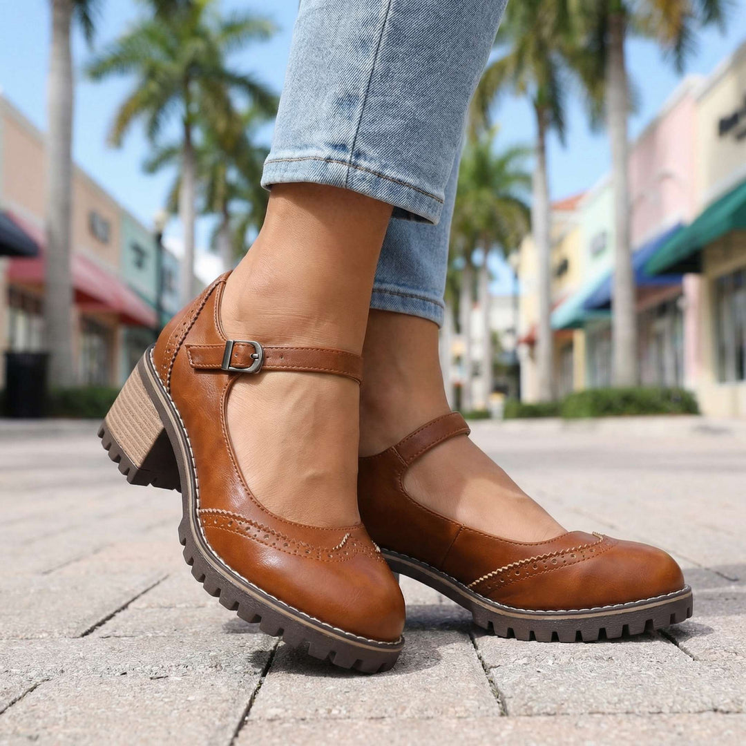 Brown pair worn on paving stones, close view of the buckle strap, brogue toe and tread sole 8