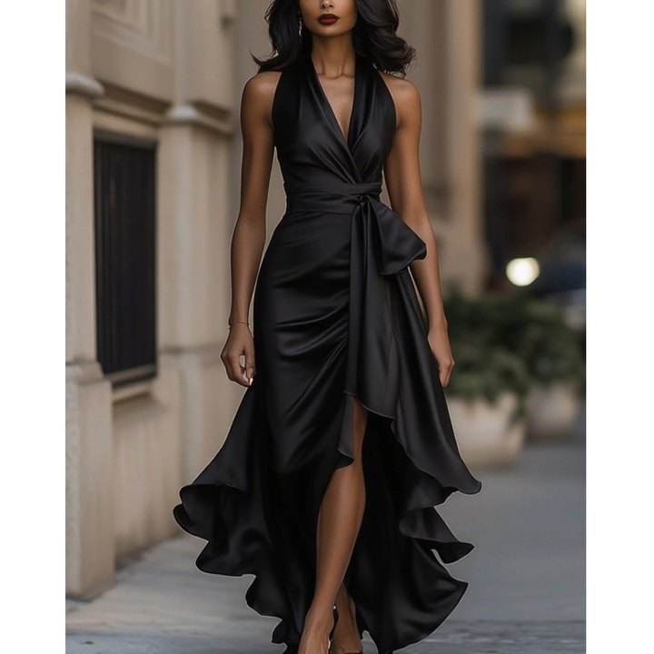 Women's satin halter dress in black, front view, with side slit and flowing ruffle.