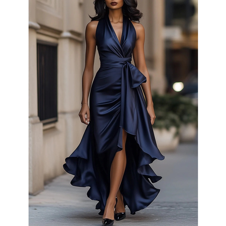Women's satin halter dress in navy, front view, showing the side tie and slit.