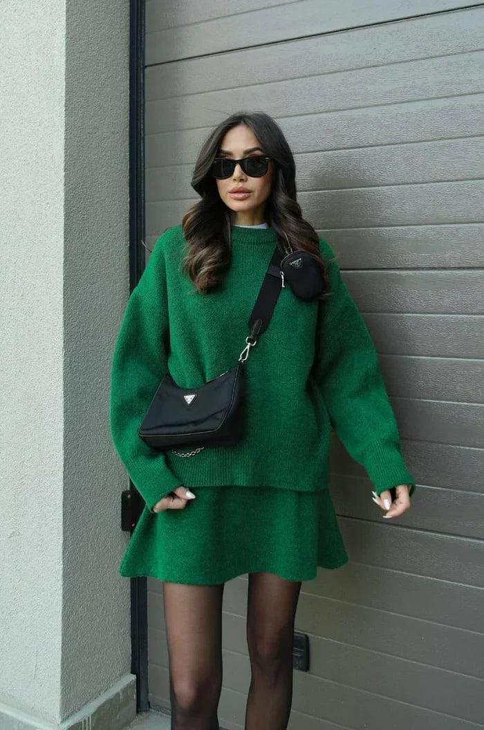 Green knit sweater and flared mini skirt with sheer tights, worn with a black crossbody bag 8