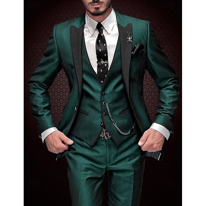 Men's three-piece suit in dark green with black peak lapels, white shirt and skull-print tie.