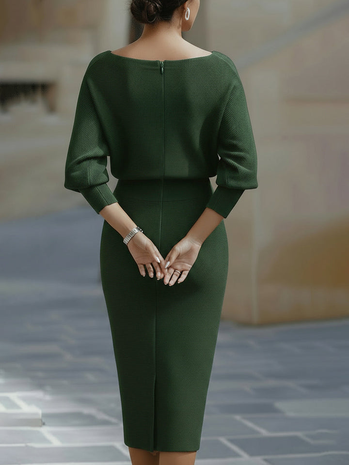 Back view of the green dress showing the center zipper, ribbed cuffs and rear skirt slit 10