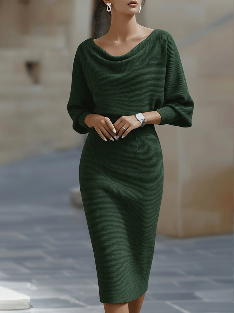 Front view of the dark green knit midi dress worn by a model with hands clasped 4