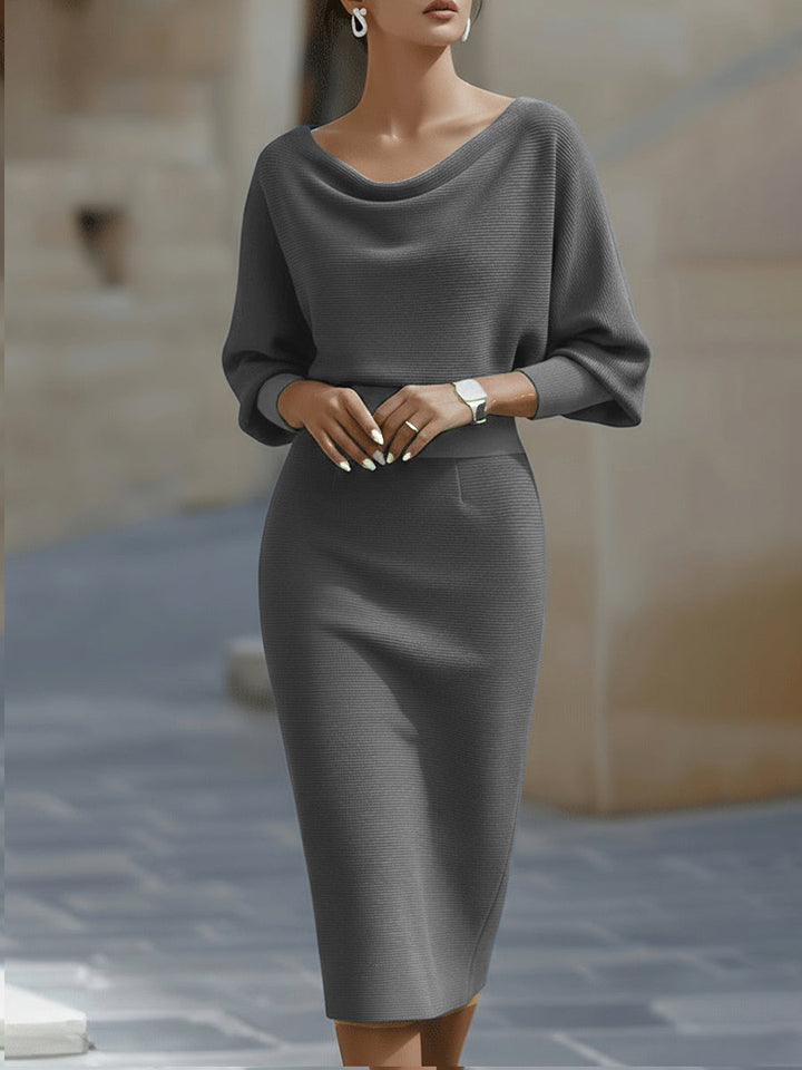 Model wearing the gray ribbed knit dress with draped neckline and fitted skirt, front view 5