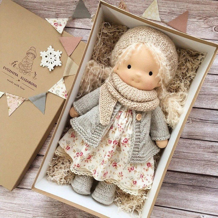 Doll with pale curly hair in a floral dress, gray knit cardigan and beige scarf, in a kraft box with paper bunting 7