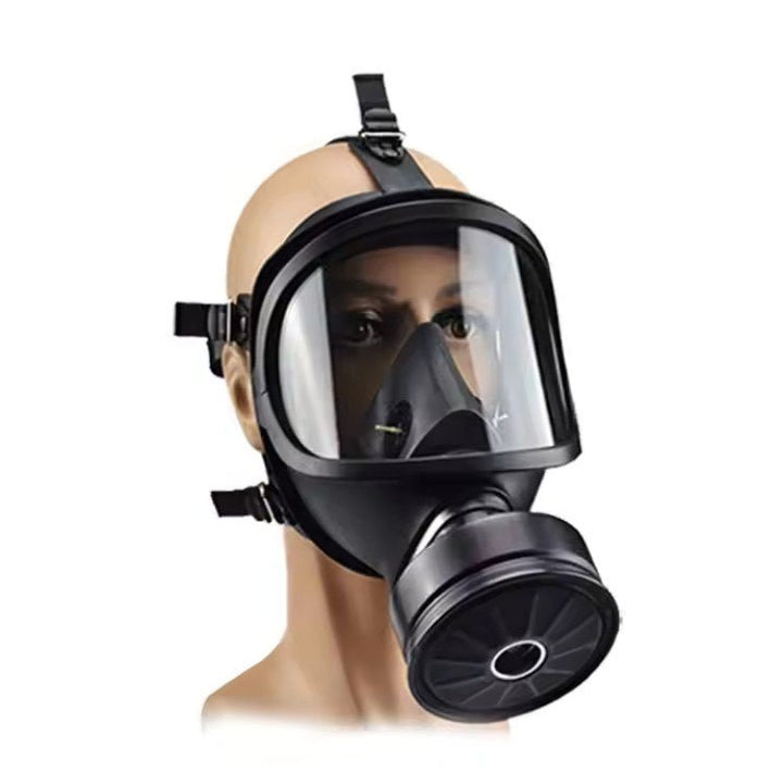 Black NBCR protective mask three-quarter view on a mannequin head with the round filter canister attached.