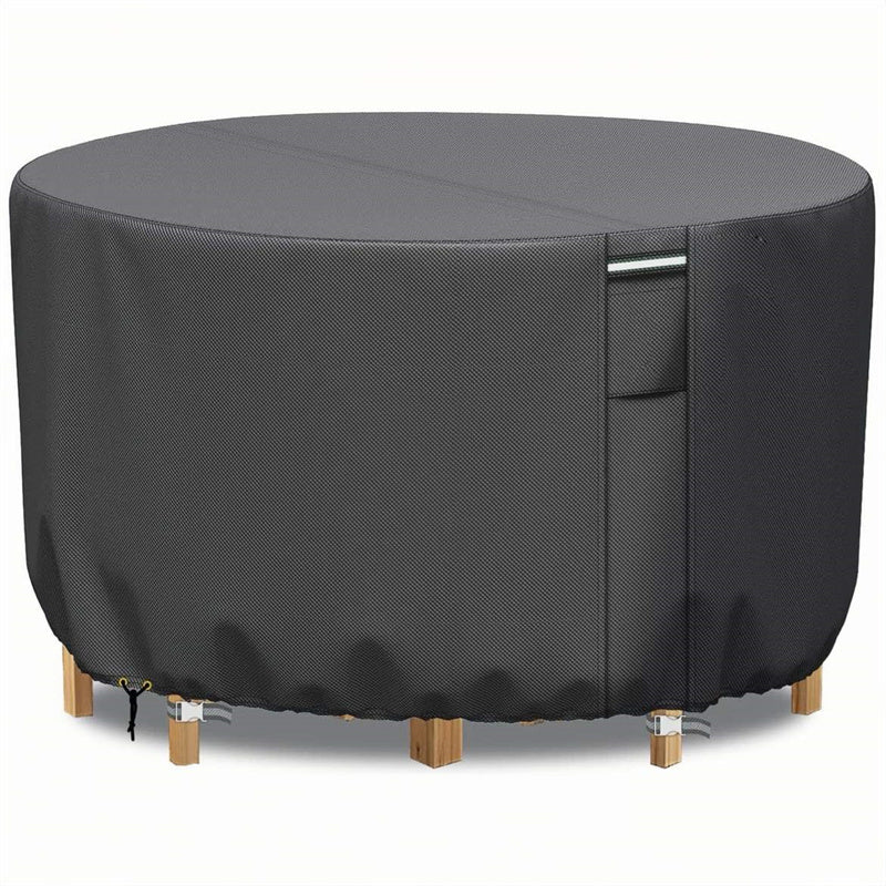Front view of a gray round patio furniture cover with a vertical handle strap, drawstring and buckle straps.