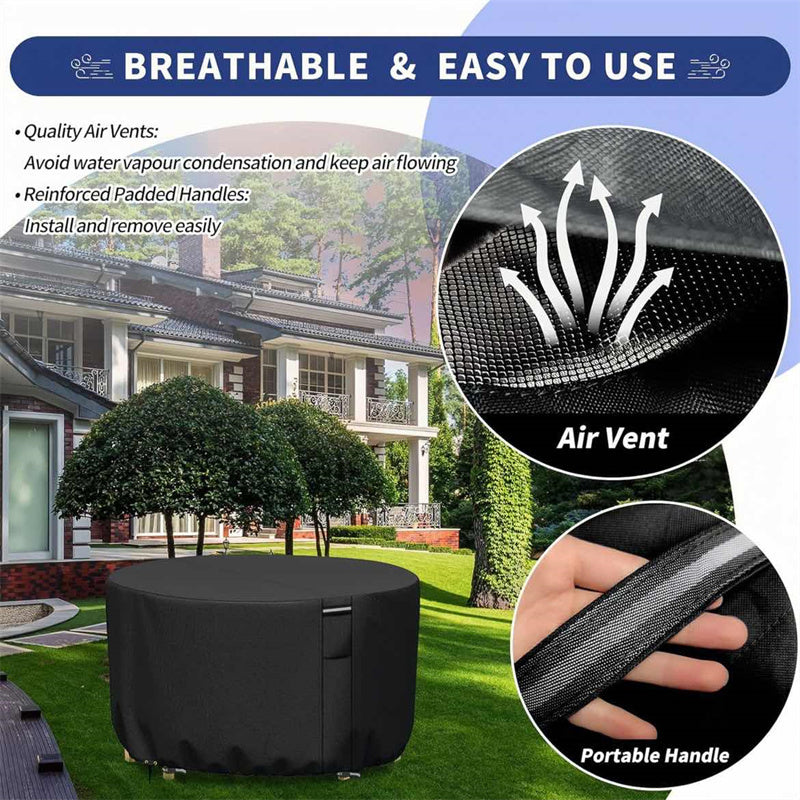 Black round patio furniture cover on a lawn showing the mesh air vent and padded carry handle.