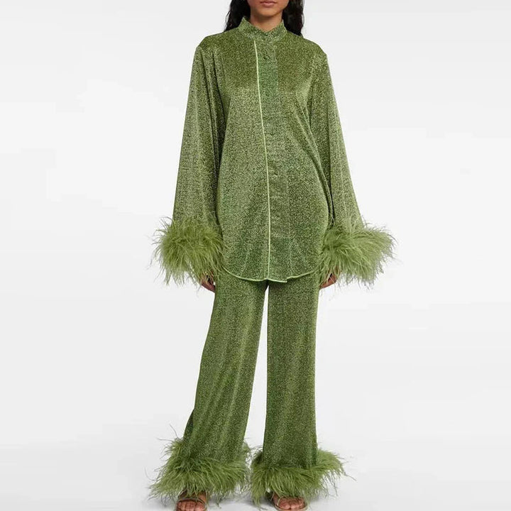 Model facing forward in an olive-green glitter set with piped shirt front and feather trim on sleeves and pant hems. 4