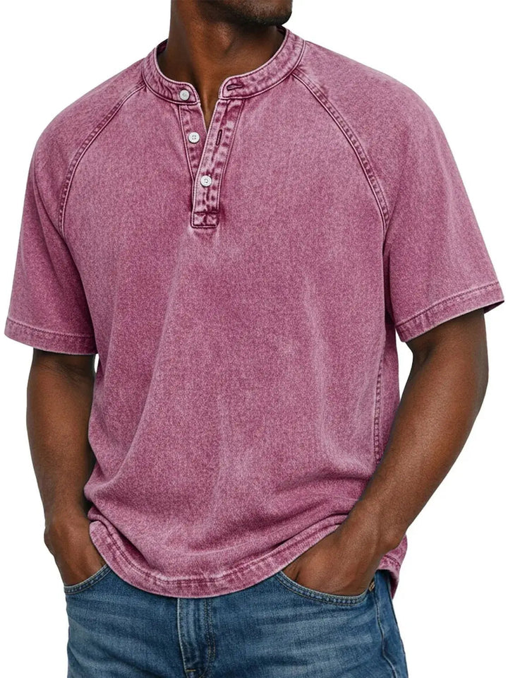 Men's washed raglan-sleeve henley in raspberry pink, front view with faded finish and buttoned collar